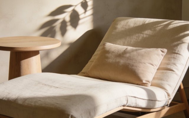 A low reclining chair in oatmeal linen in a quiet consultation corner
